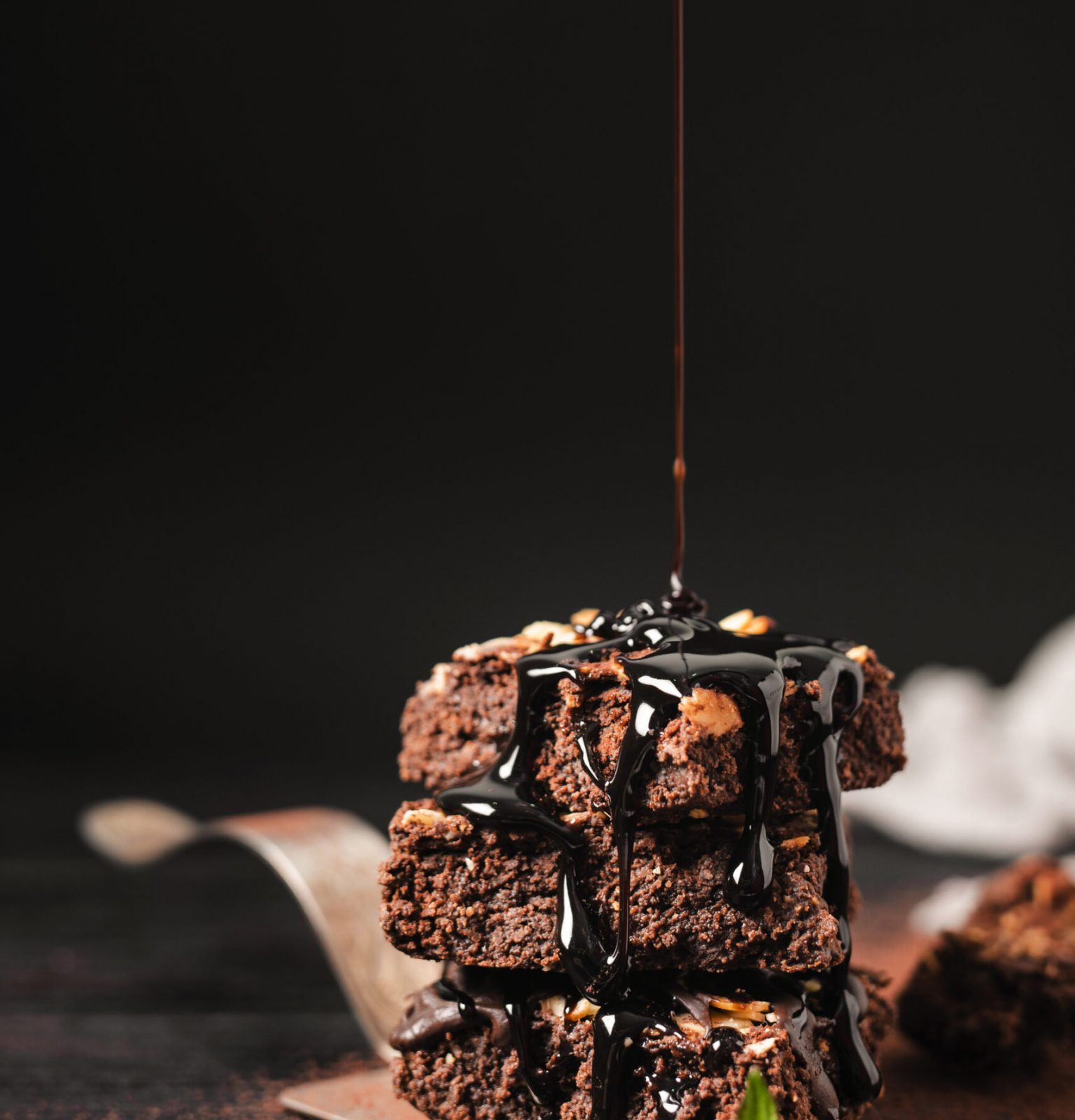 chocolate-syrup-poured-tower-chocolate-nut-brownies-tray